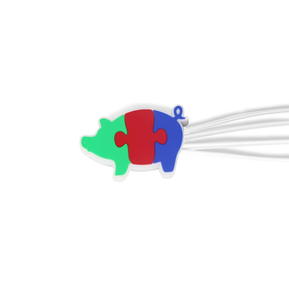 A pig-shaped cable organiser in green, red, and blue, with multiple white charging cables attached.
