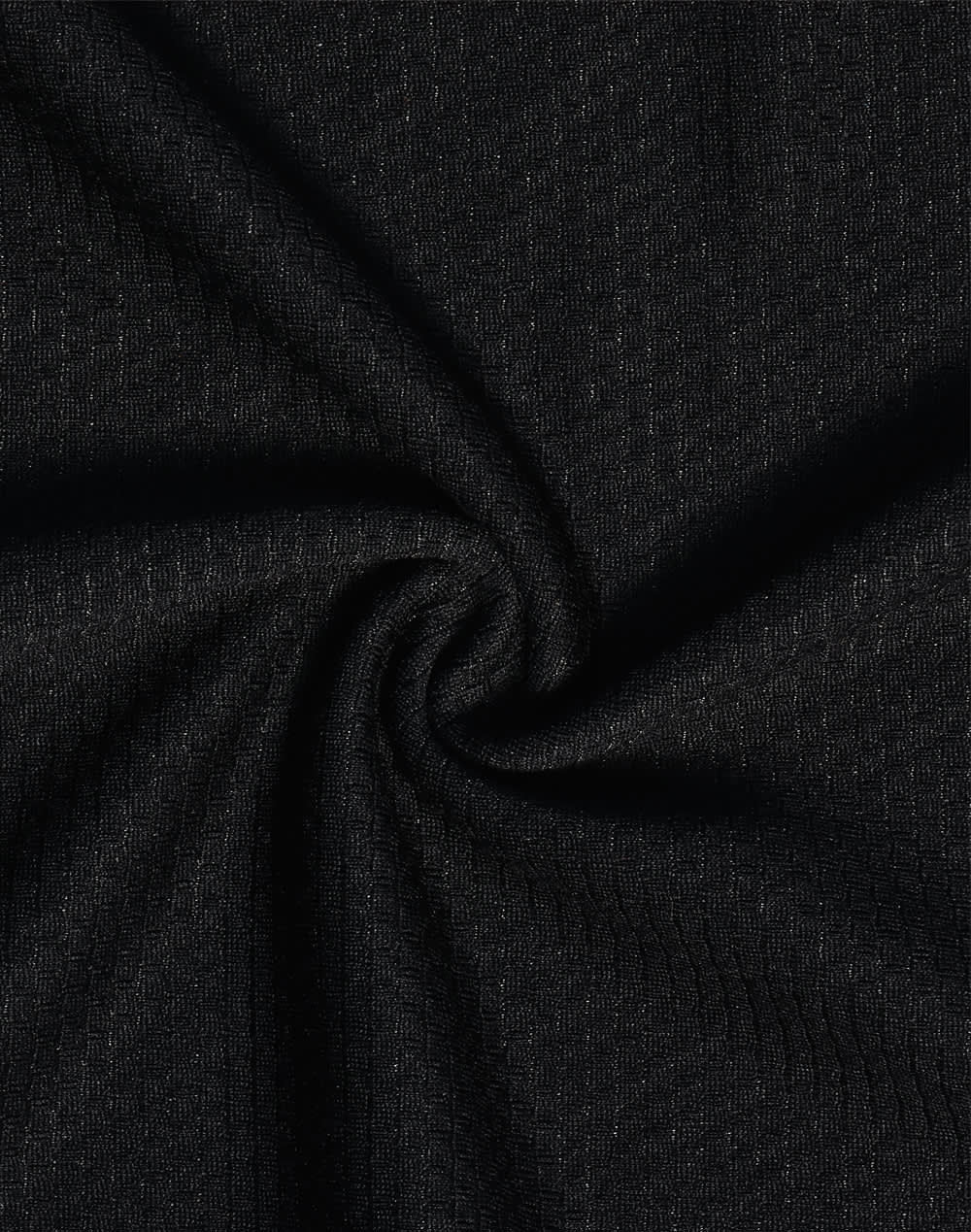 A close-up view of black textured fabric, showcasing a woven pattern suitable for polo shirts.