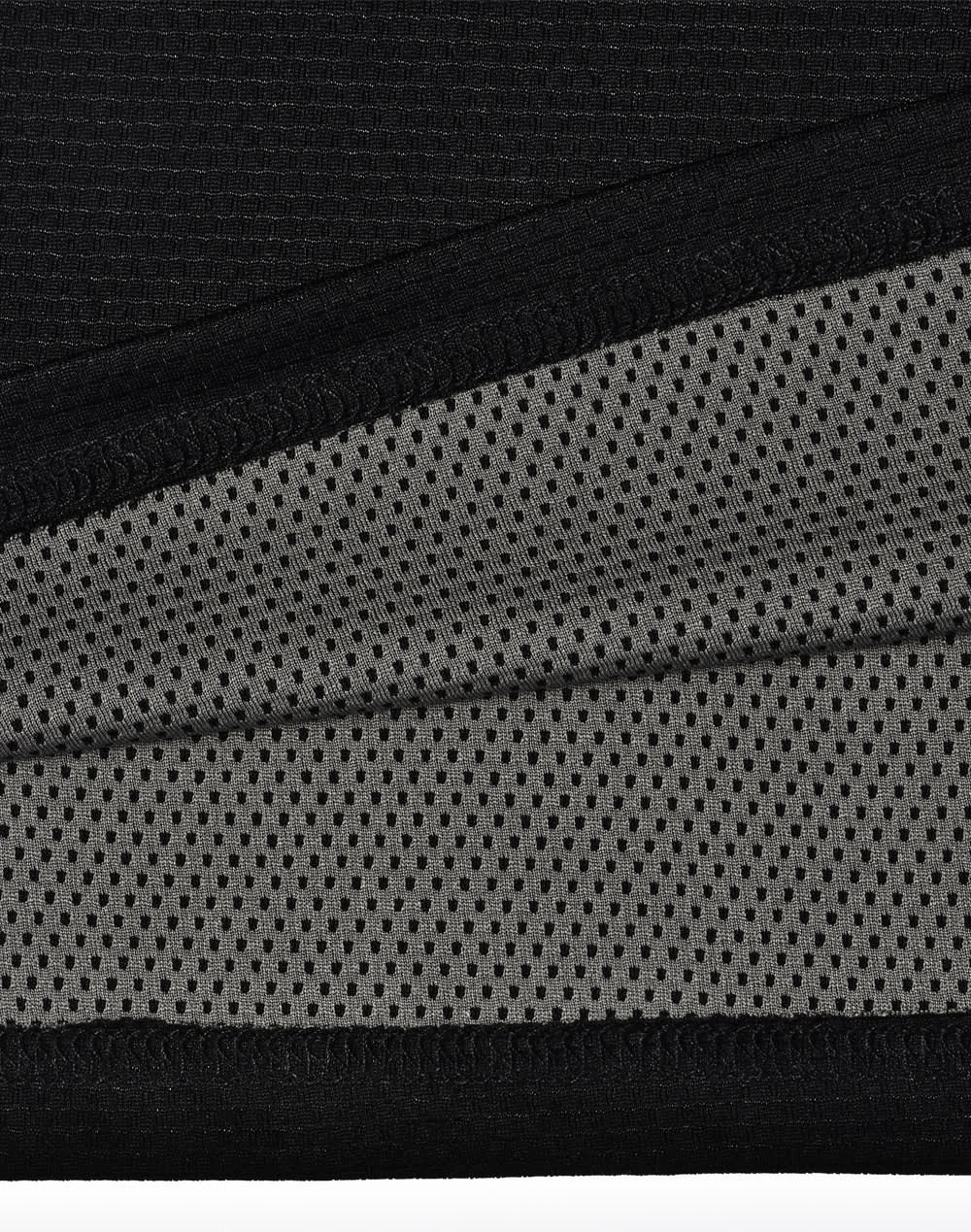 A close-up of a black polo shirt featuring a breathable grey mesh fabric beneath. The shirt includes a logo.
