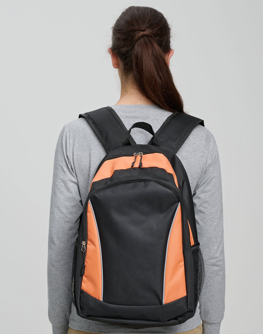 A black and orange backpack with padded shoulder straps and a zippered pocket on the front.