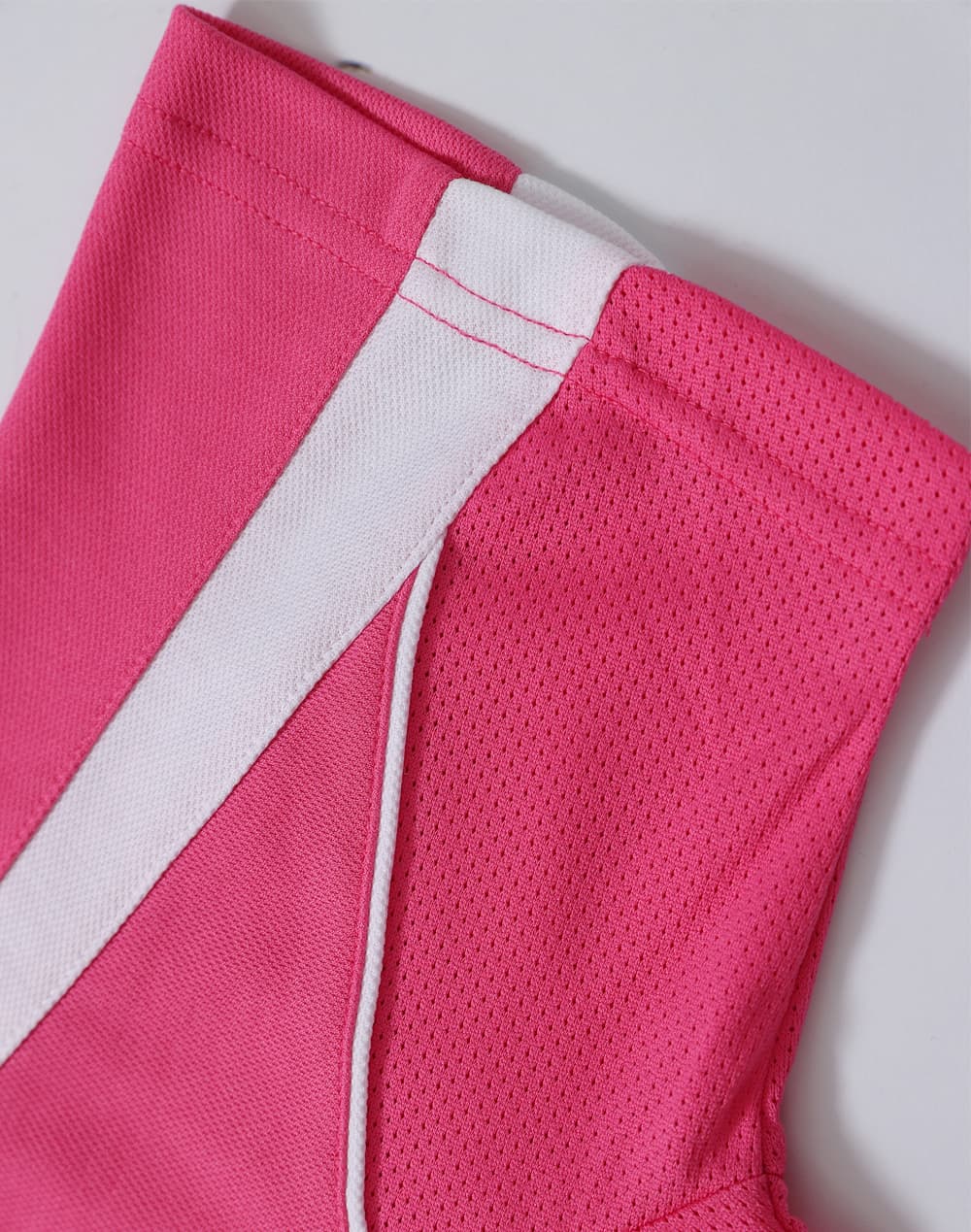 A pink short-sleeved sport polo shirt with white detailing and a logo.