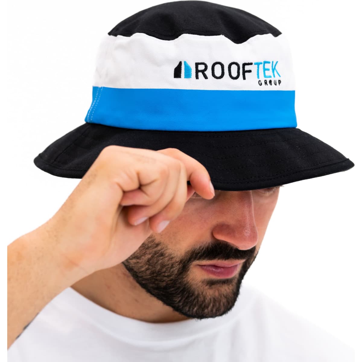 A black and white bucket hat with a blue band, featuring a logo on the front.