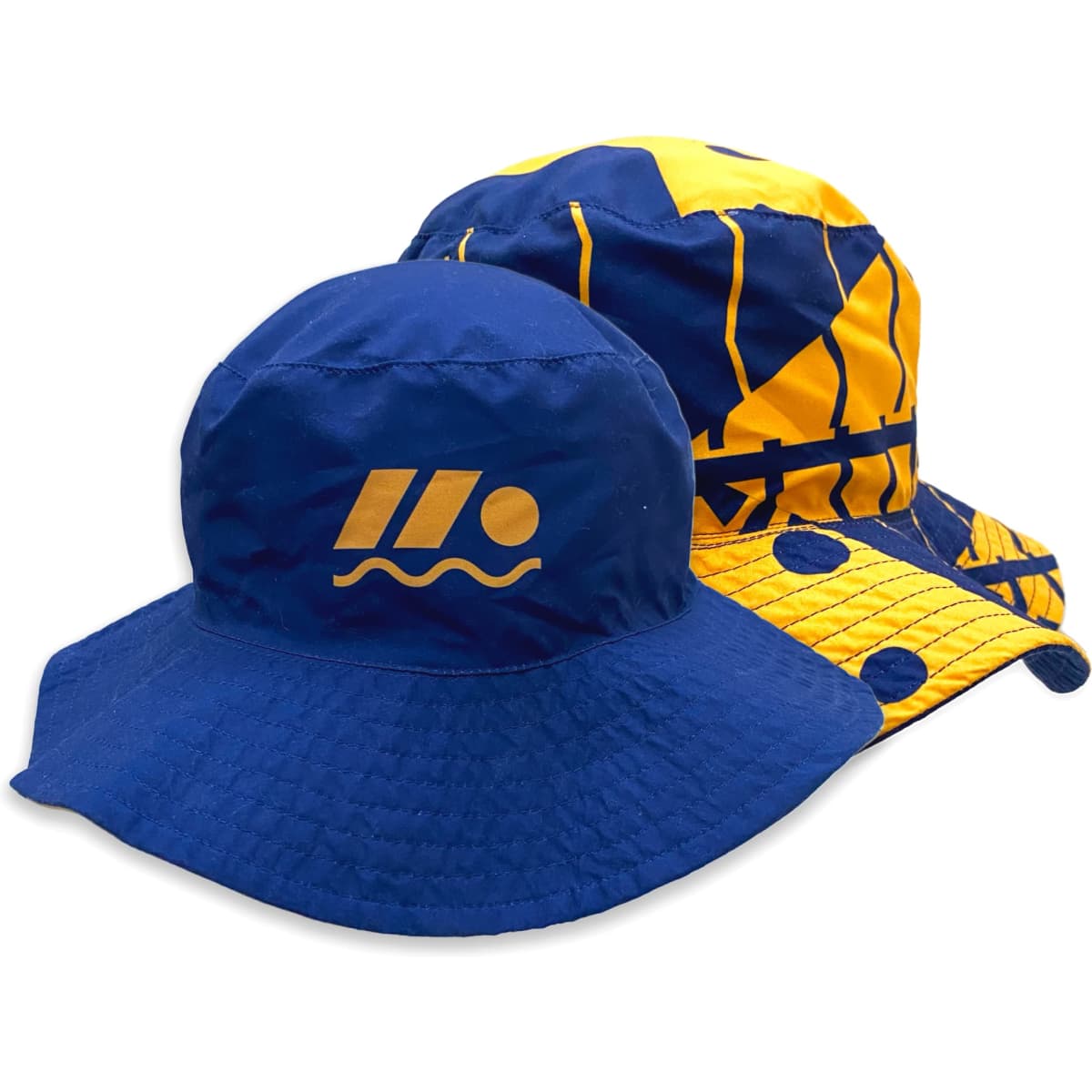 A reversible bucket hat featuring a blue side with a logo and a yellow side with patterns.