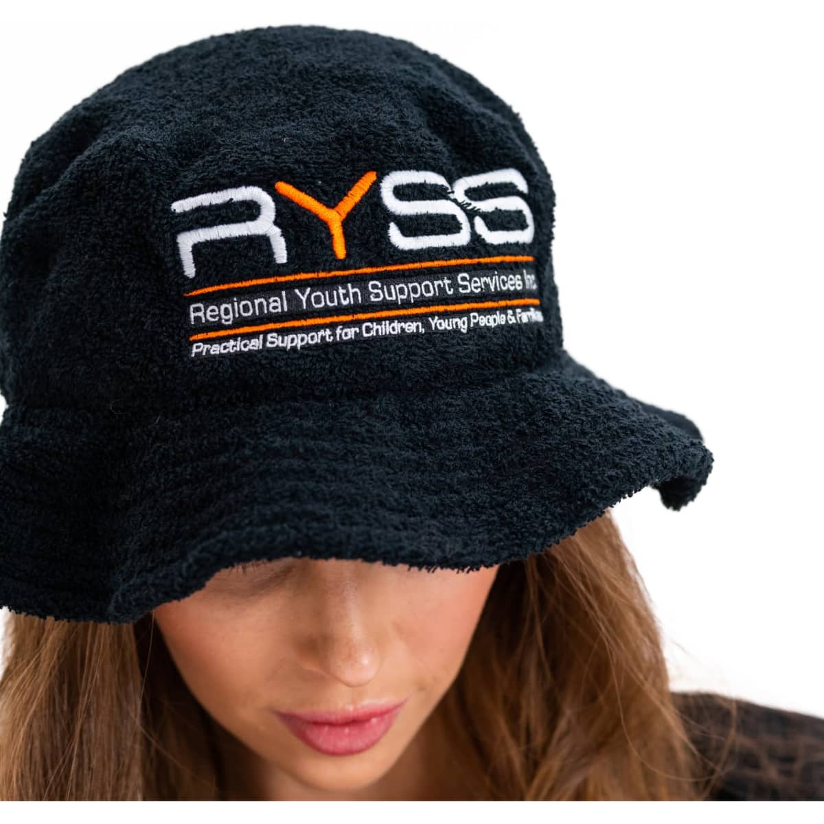 A black terry towelling bucket hat features a logo and is made of soft, textured fabric.