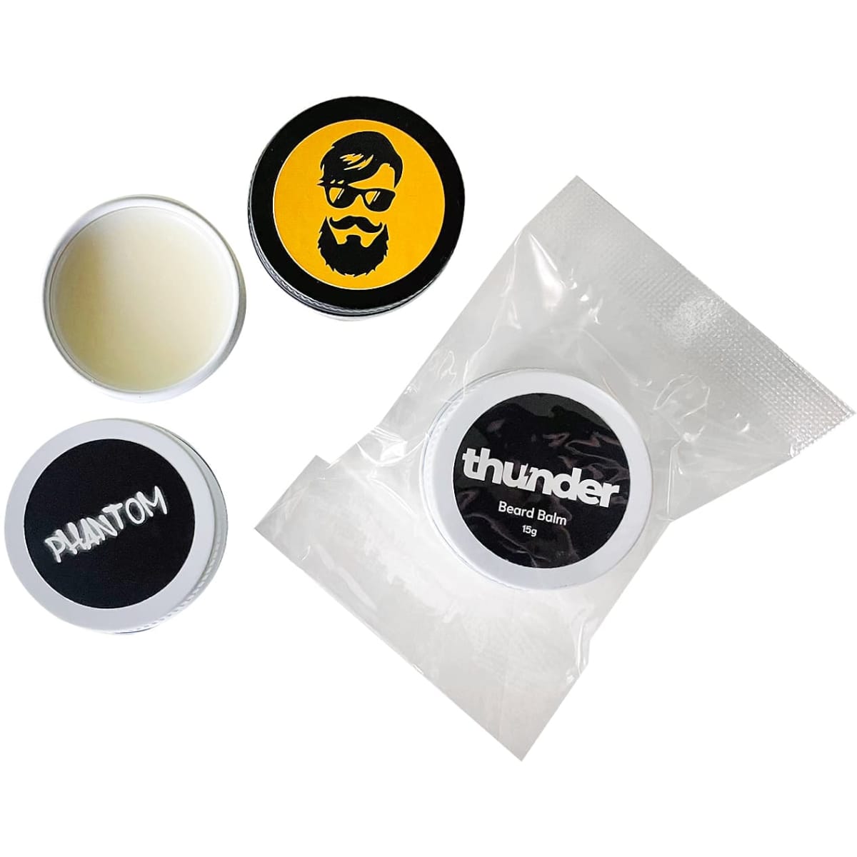 Beard balm tins in various designs and colours, including a twist-top tin and a clear packaging.