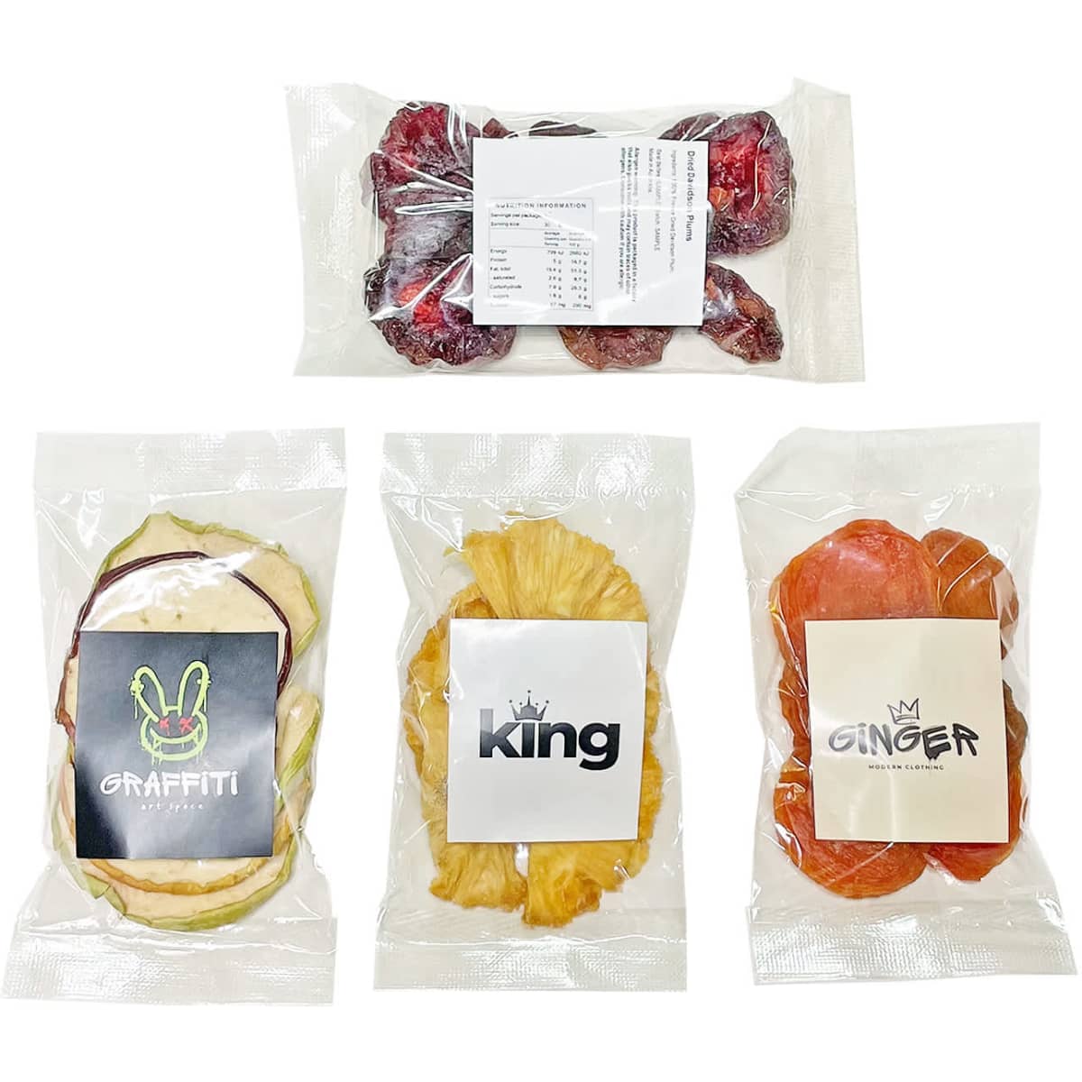 Dried fruit snack bags featuring assorted fruits in vibrant colours, packaged in clear wrappers with logos.