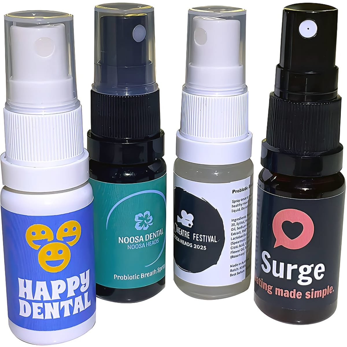 Four spray bottles in various colours, featuring logos, containing probiotic breath fresheners.