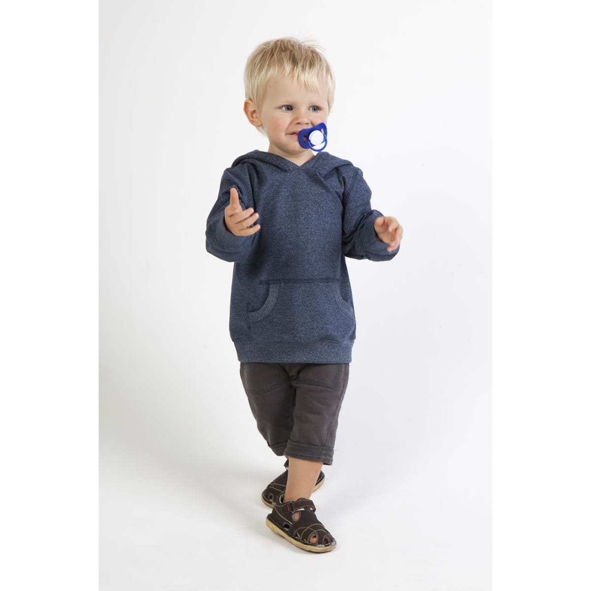 A blue heather hoodie on a toddler, paired with dark shorts and sandals, with a pacifier in their mouth.
