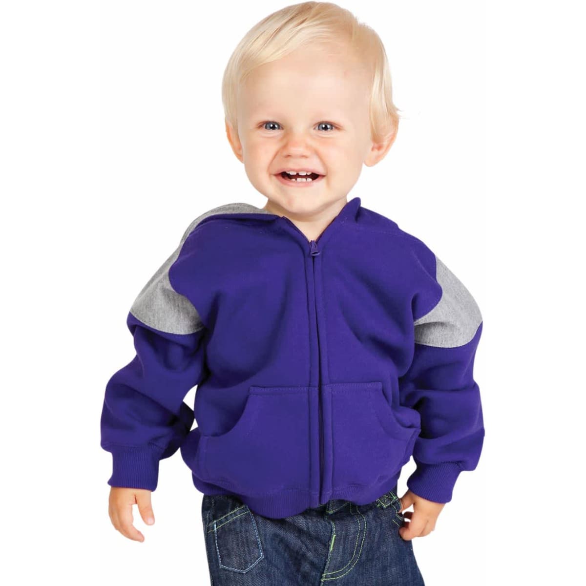A smiling toddler in a purple hoodie with grey panels and jeans, walking against a plain white background.