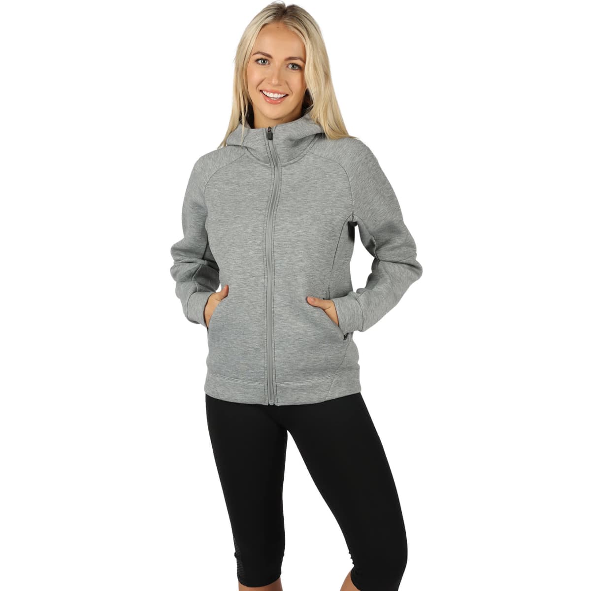 A grey women's junior hoodie featuring a zip-up front and side pockets, modelled by a smiling woman.