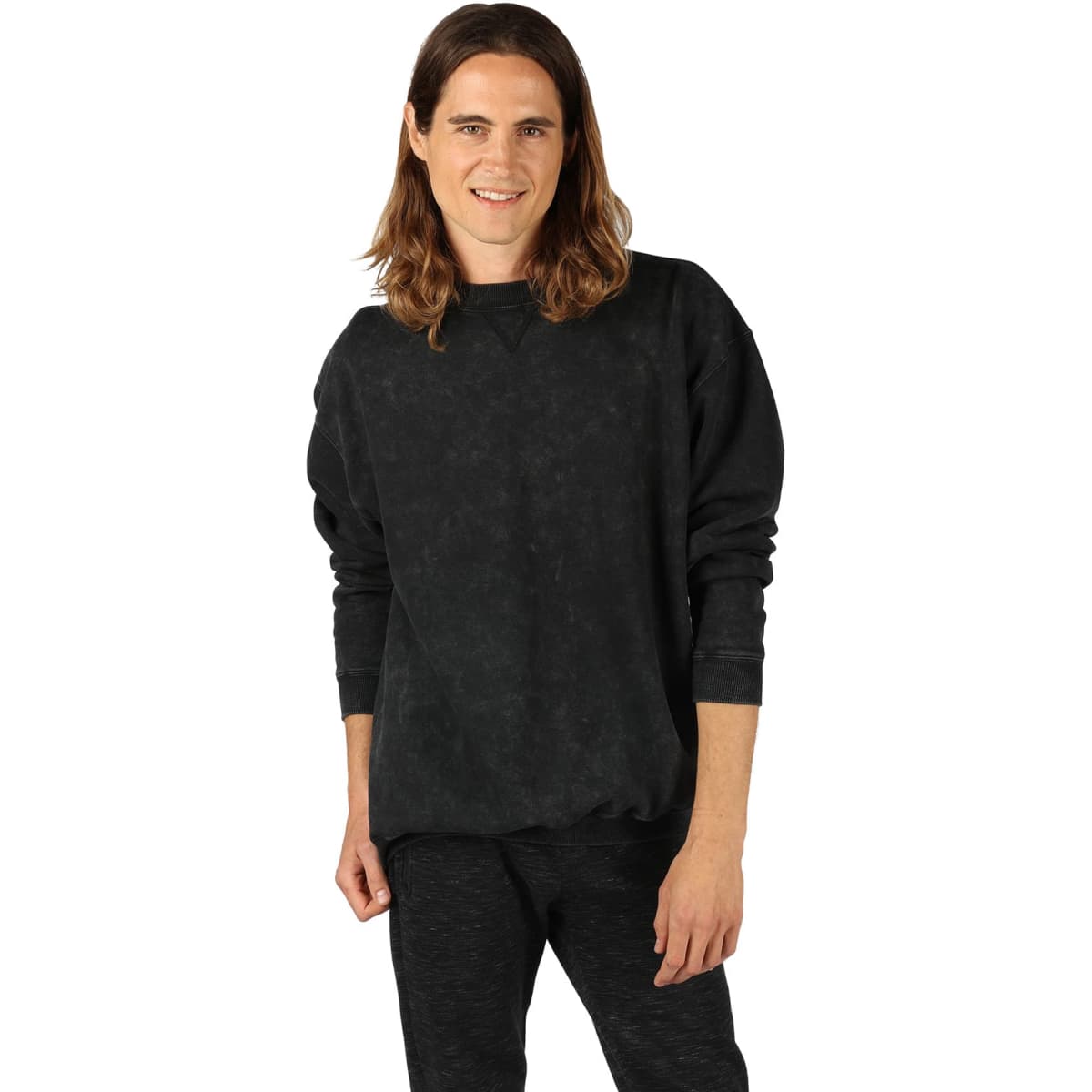A unisex stone wash sweatshirt in black, featuring a crew neck and long sleeves. The model is posing casually.