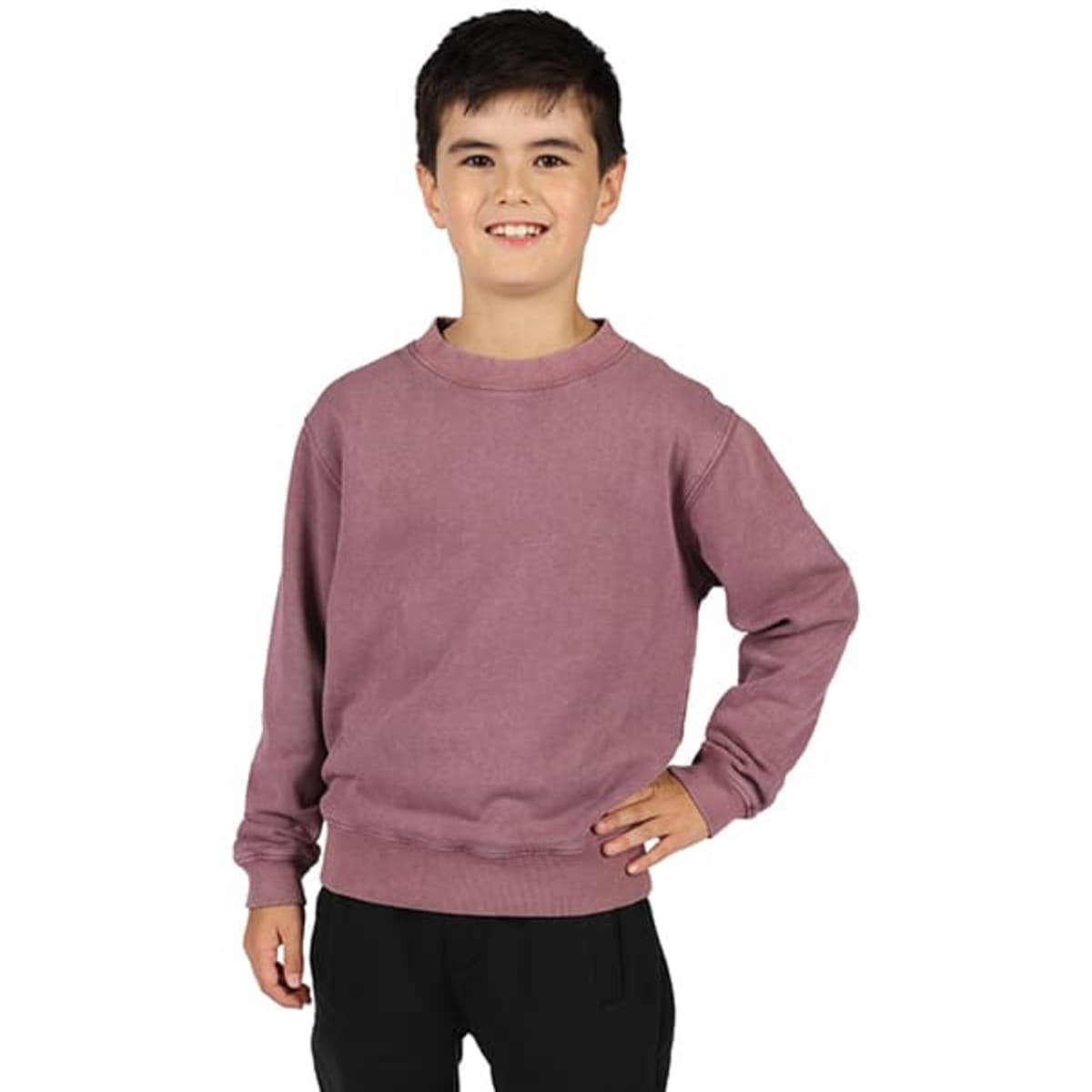 A child wearing a mauve stone wash sweatshirt, smiling and standing with one hand on their hip.