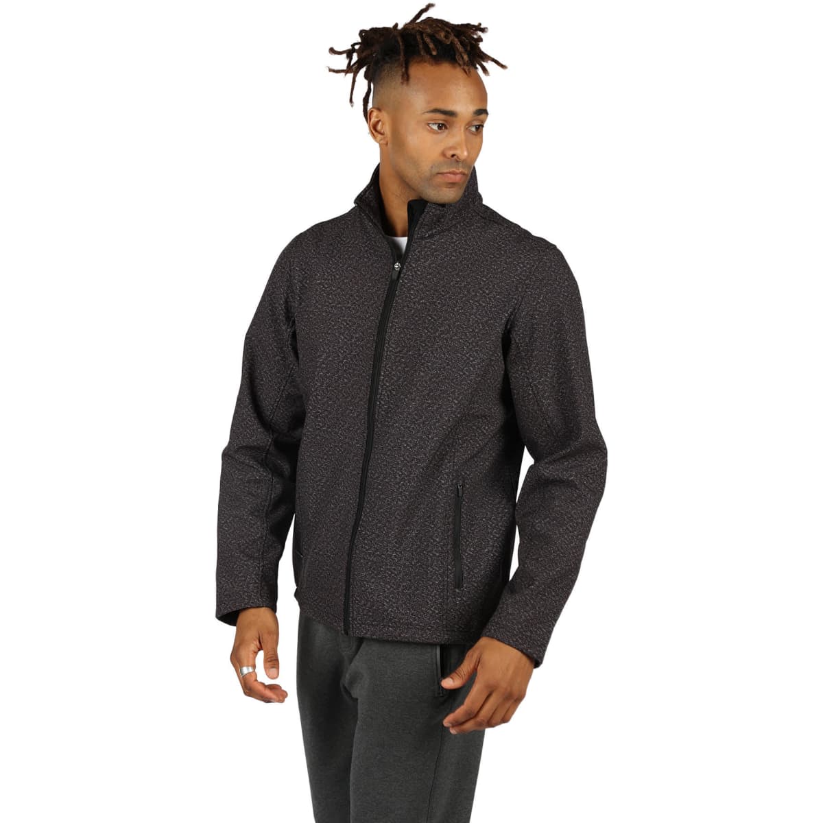A man is wearing a black patterned soft shell jacket with a zip front and pockets. The jacket features a logo.