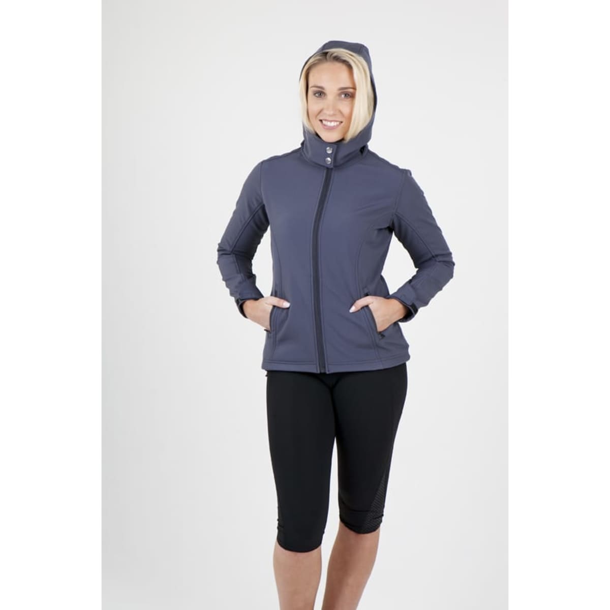 A women’s soft shell jacket in navy grey, featuring a hood and zippered front, with hand pockets. The model has a cheerful expression.