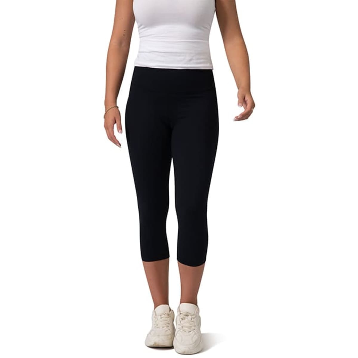 High-rise 3/4 leggings in black, styled with a white top and white shoes, featuring a logo on the waistband.