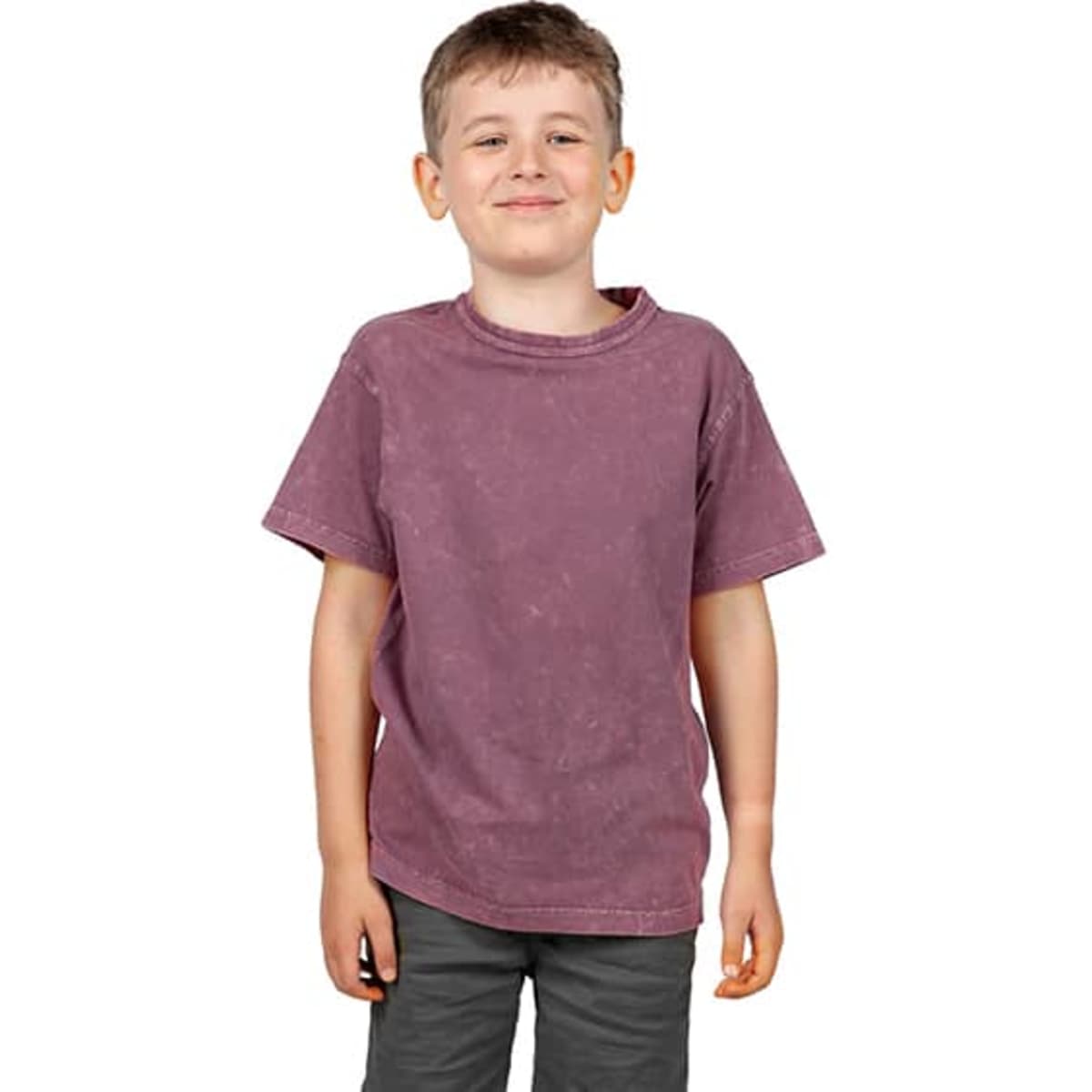 A stone wash T-shirt in a muted purple shade, worn by a smiling boy, with a simple logo on the shirt.