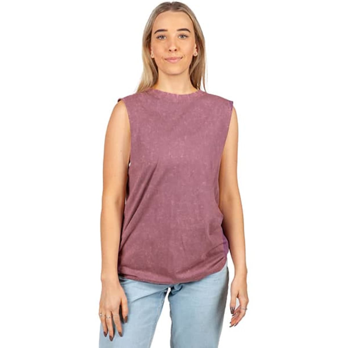 A woman wearing a stone-washed, sleeveless tank top in a mauve colour with a relaxed fit. The top has a branding logo.