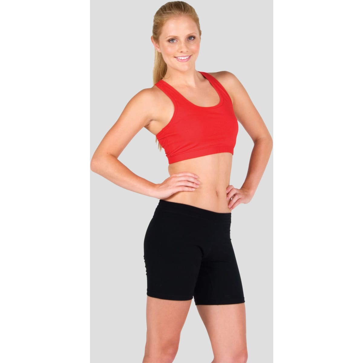 A red crop top with a fitted design, paired with black shorts, showcased on a model against a grey background.
