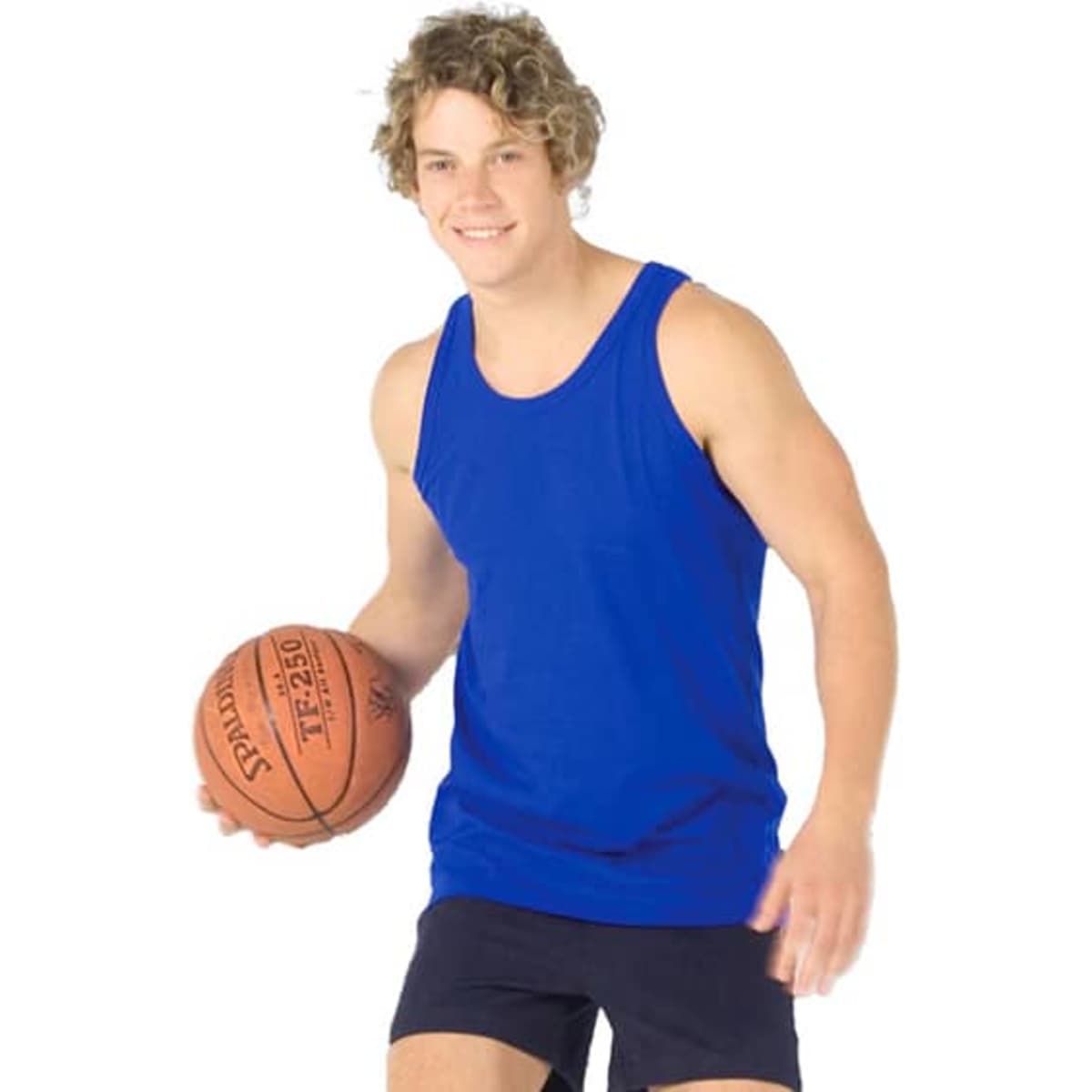 A man is wearing a blue cotton singlet while holding a basketball, smiling at the camera.