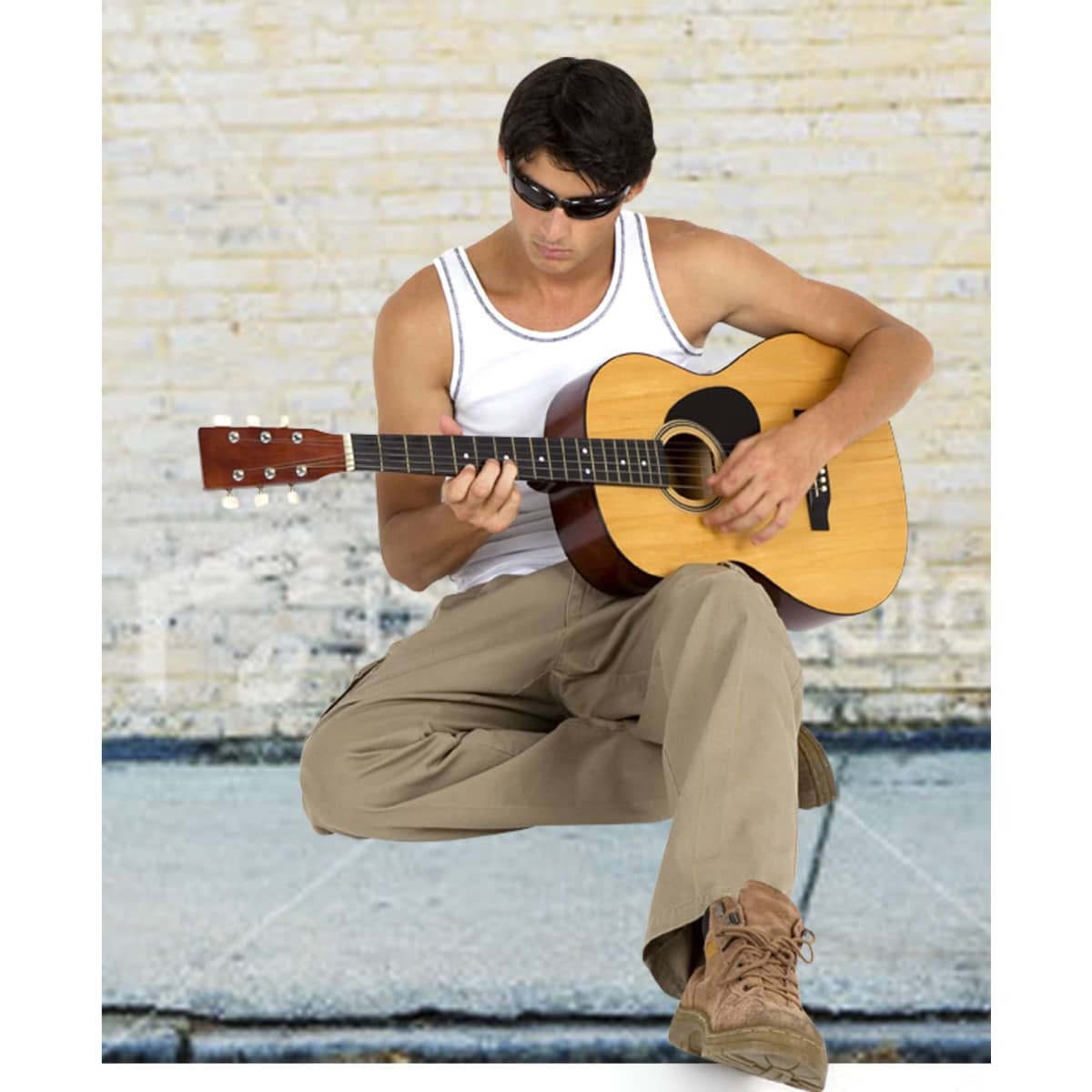 A man in a white cotton rib singlet plays an acoustic guitar, wearing sunglasses and beige pants.