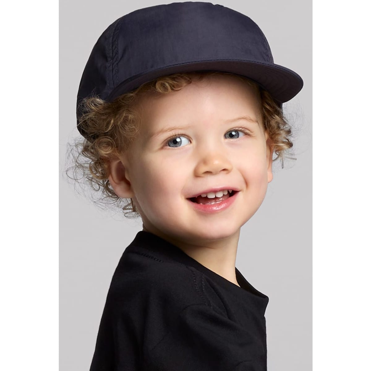 A navy cap designed for kids, featuring a structured brim and an adjustable fit.