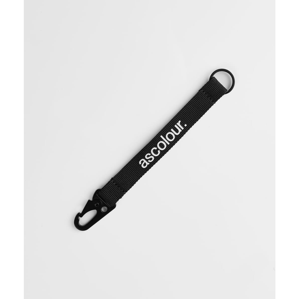 A black keychain made of fabric with a clip and a branding logo.