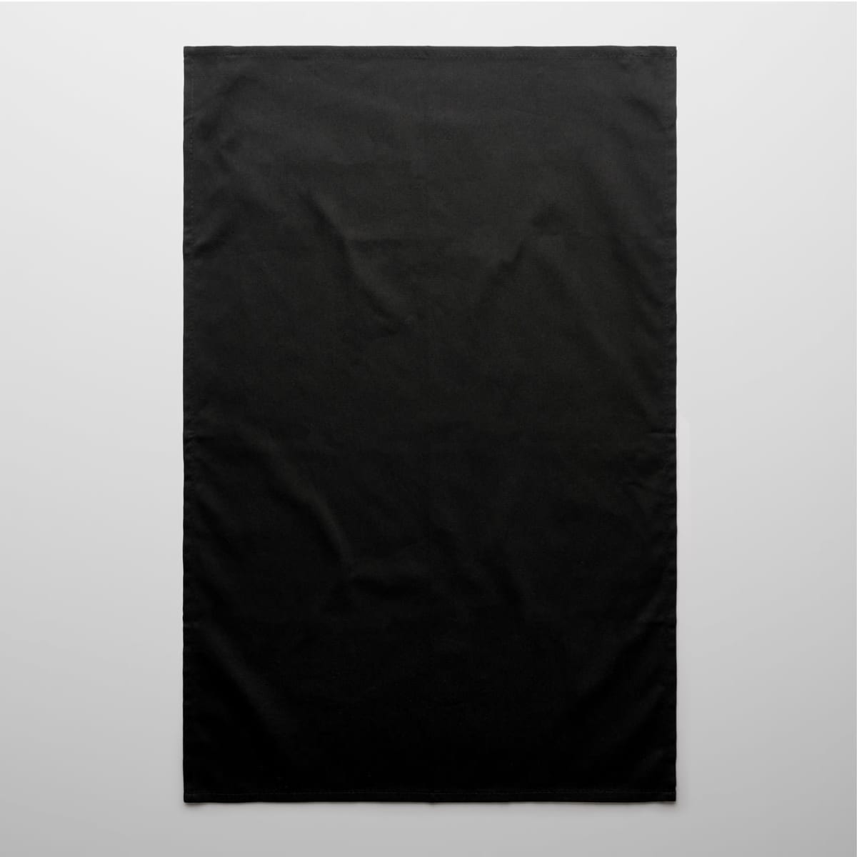 A black tea towel featuring a plain design and a small logo in the corner.