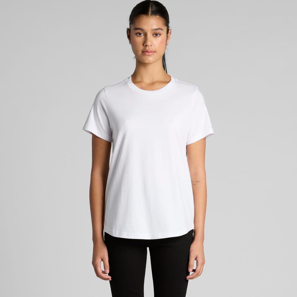 A white t-shirt with a relaxed fit and short sleeves, featuring a subtle logo.