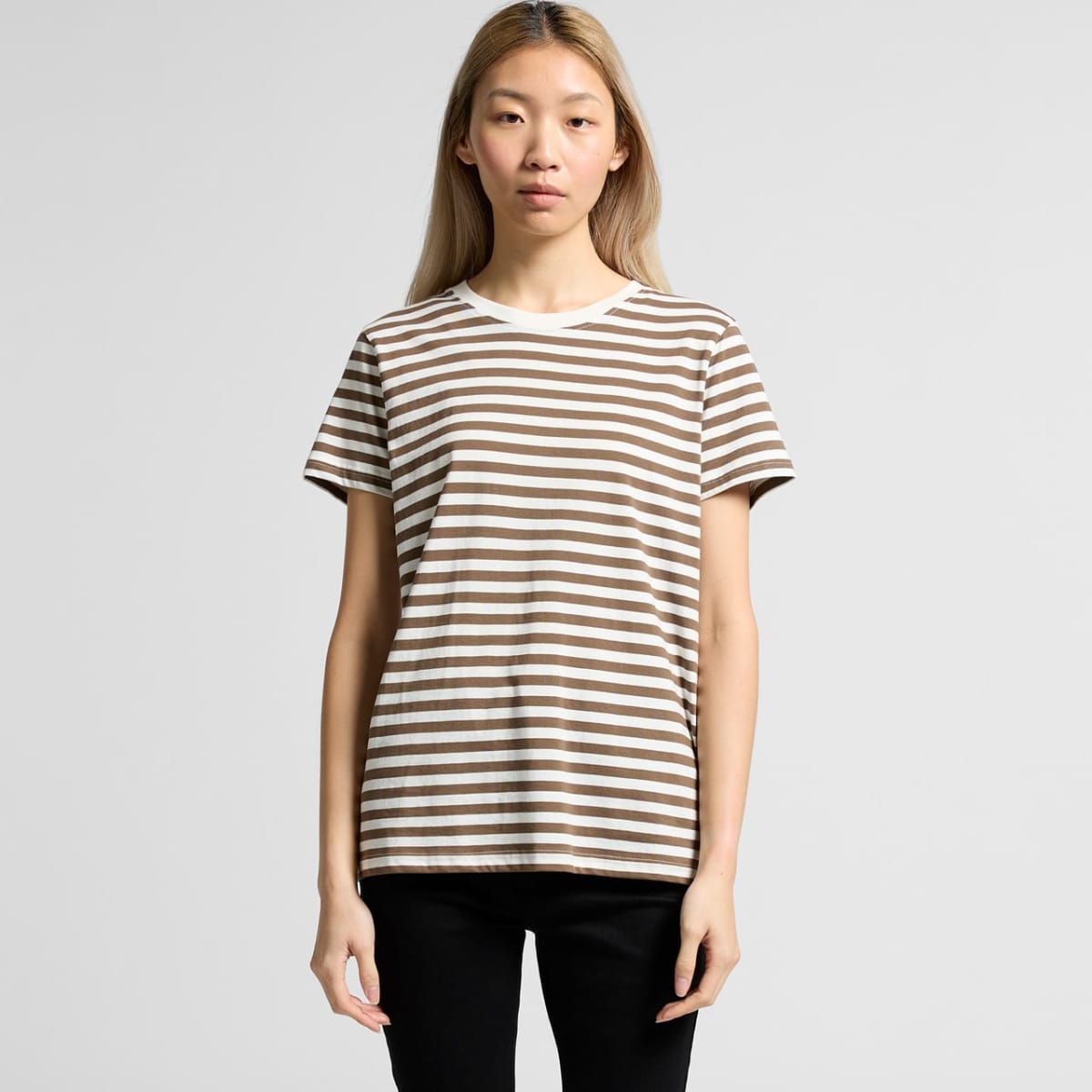 A person wearing a brown and white striped T-shirt with a round neckline, featuring short sleeves.