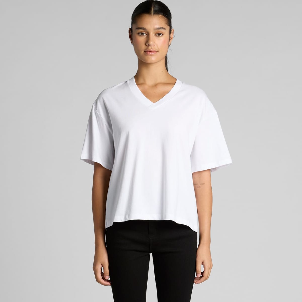 A white V-neck t-shirt with short sleeves, featuring a relaxed fit and a brand logo.
