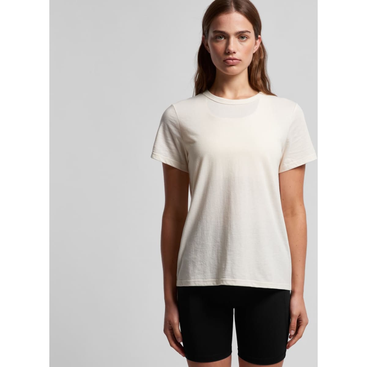 A light cream-coloured t-shirt with a relaxed fit, featuring a simple design and a small logo on the label.