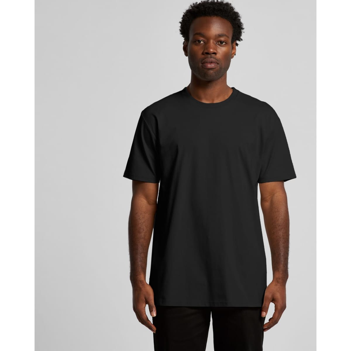 A black recycled T-shirt with short sleeves displayed on a model against a plain background. The shirt has a logo.