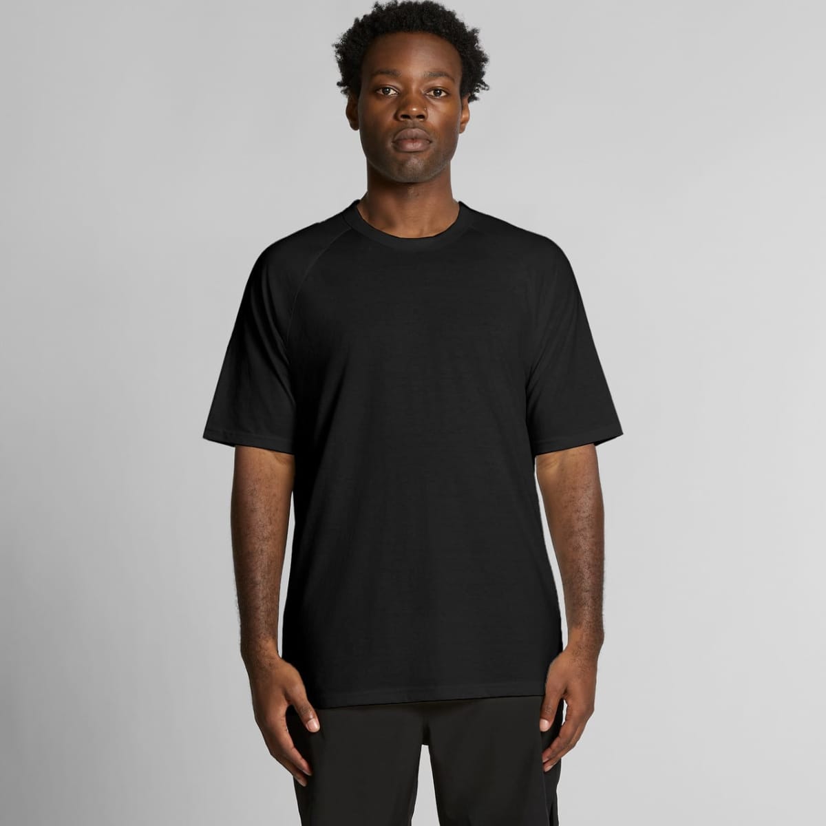 A black t-shirt with short sleeves, featuring a basic design and a logo.