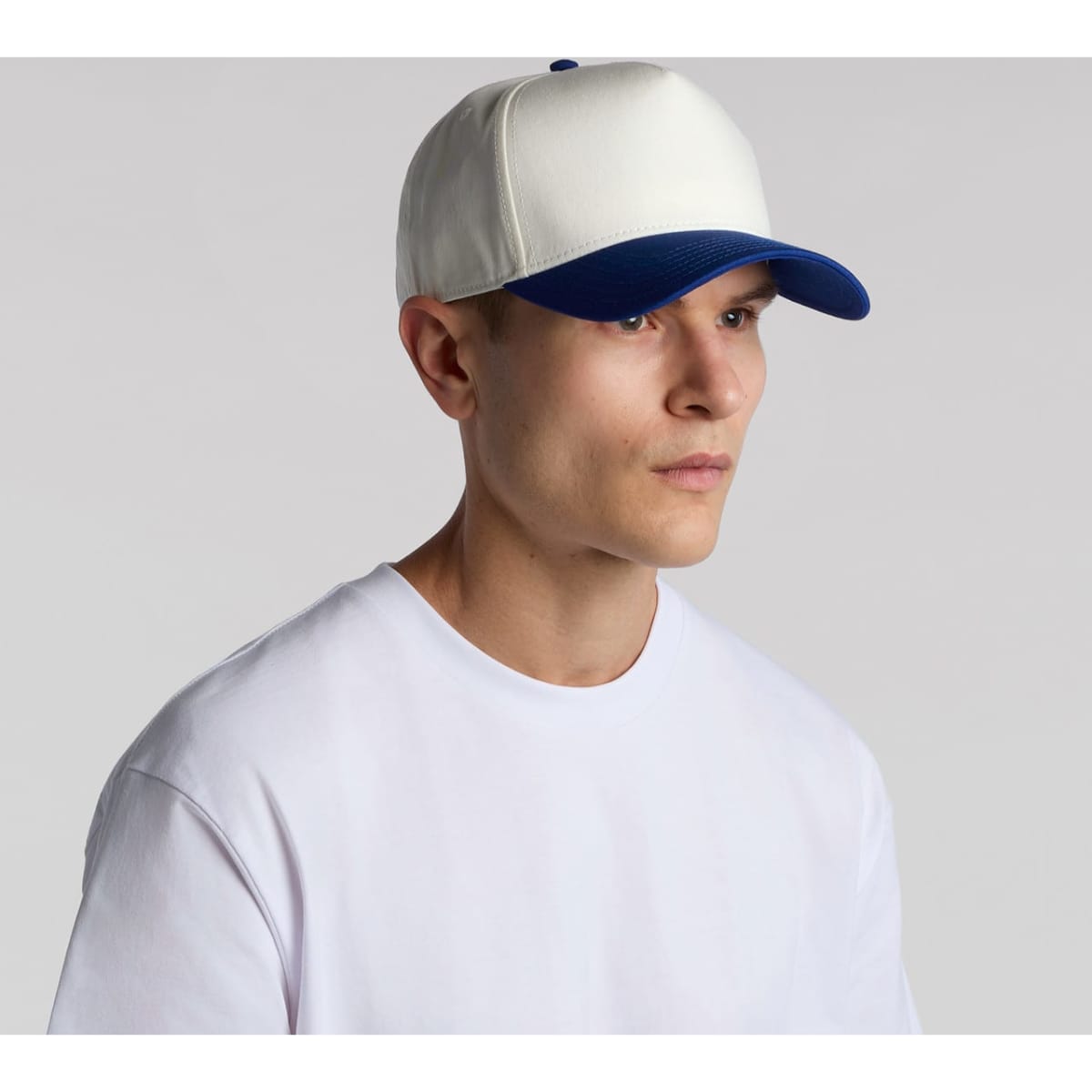 A two-tone cap featuring a white front and blue peak, designed with a logo.