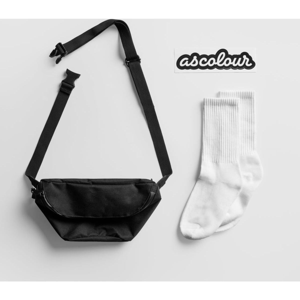 A black crossbody bag and a pair of white socks with a logo.