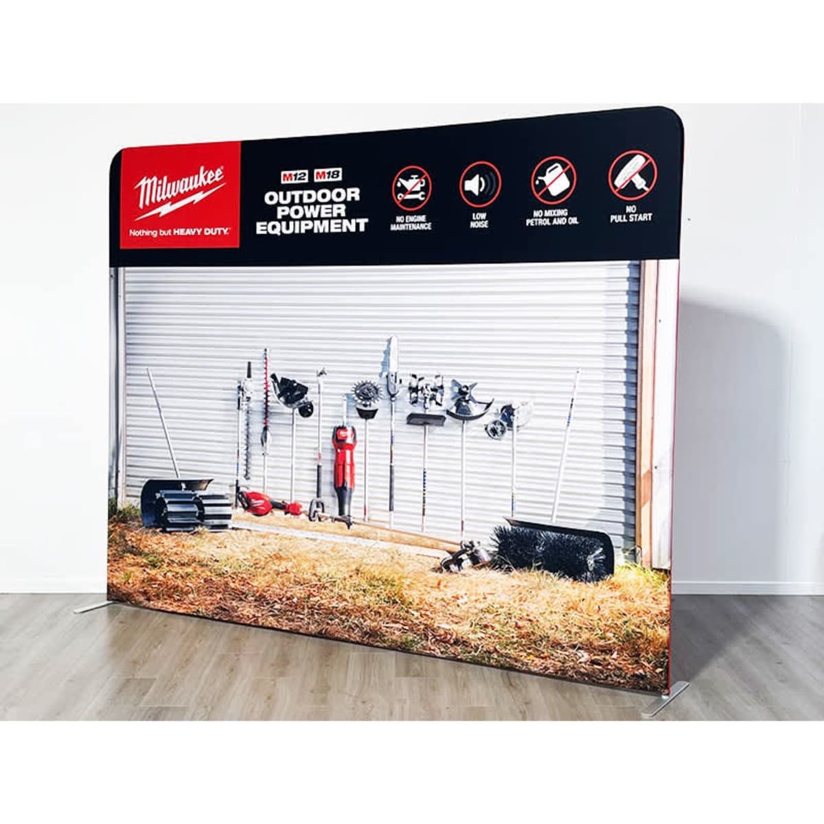 A straight tube fabric stand featuring tools and equipment against a grey wall backdrop. The stand includes a logo.