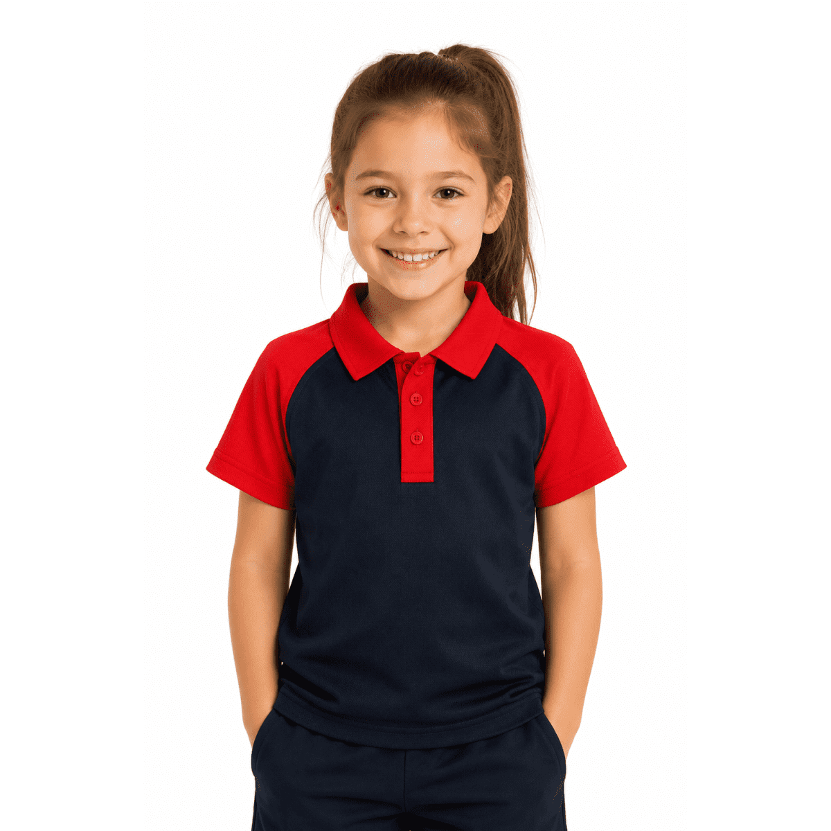 A girl smiles while wearing a navy blue and red polo shirt. The shirt features a logo on the front.