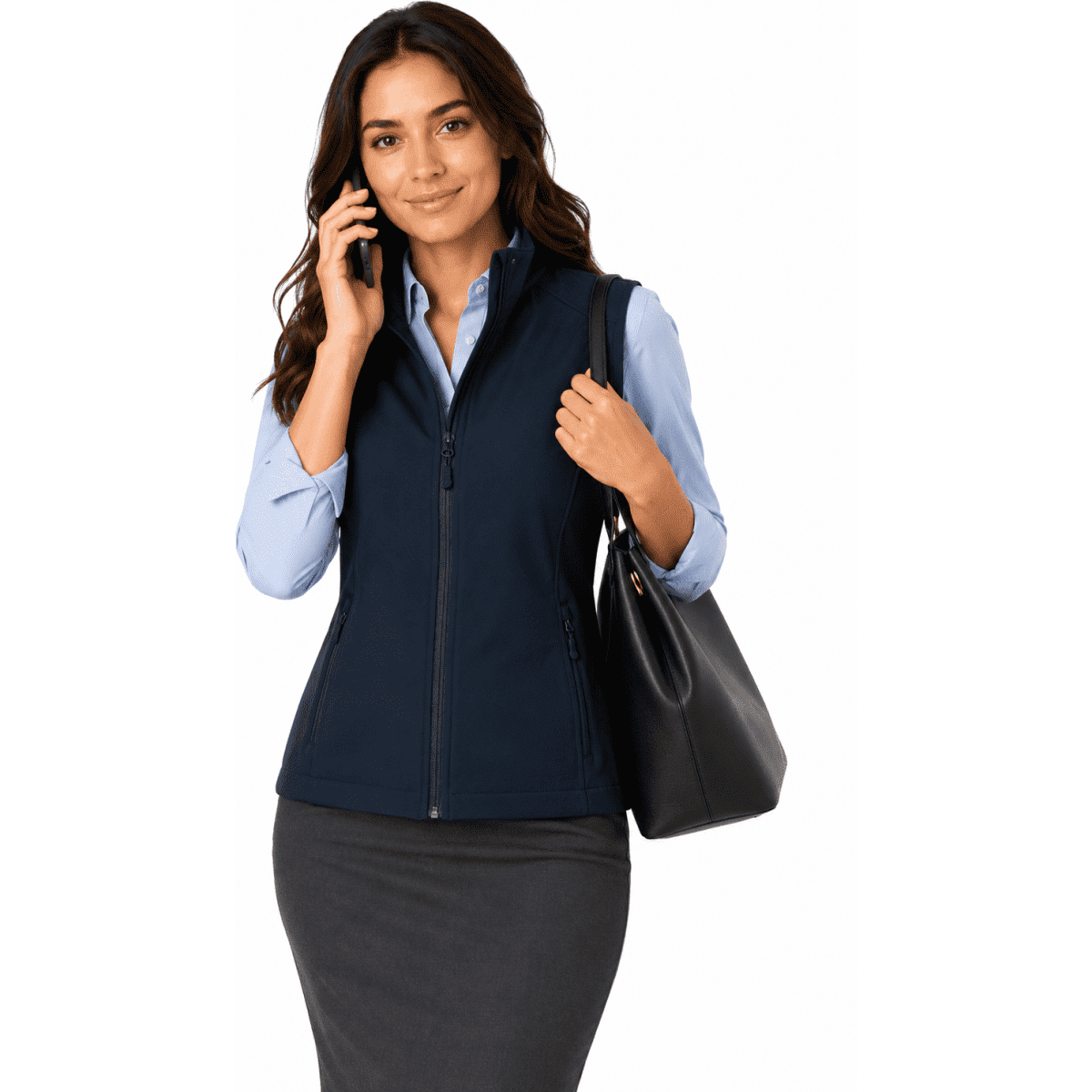 A woman wearing a navy vest, holding a handbag and talking on the phone, paired with a light blue shirt and skirt.
