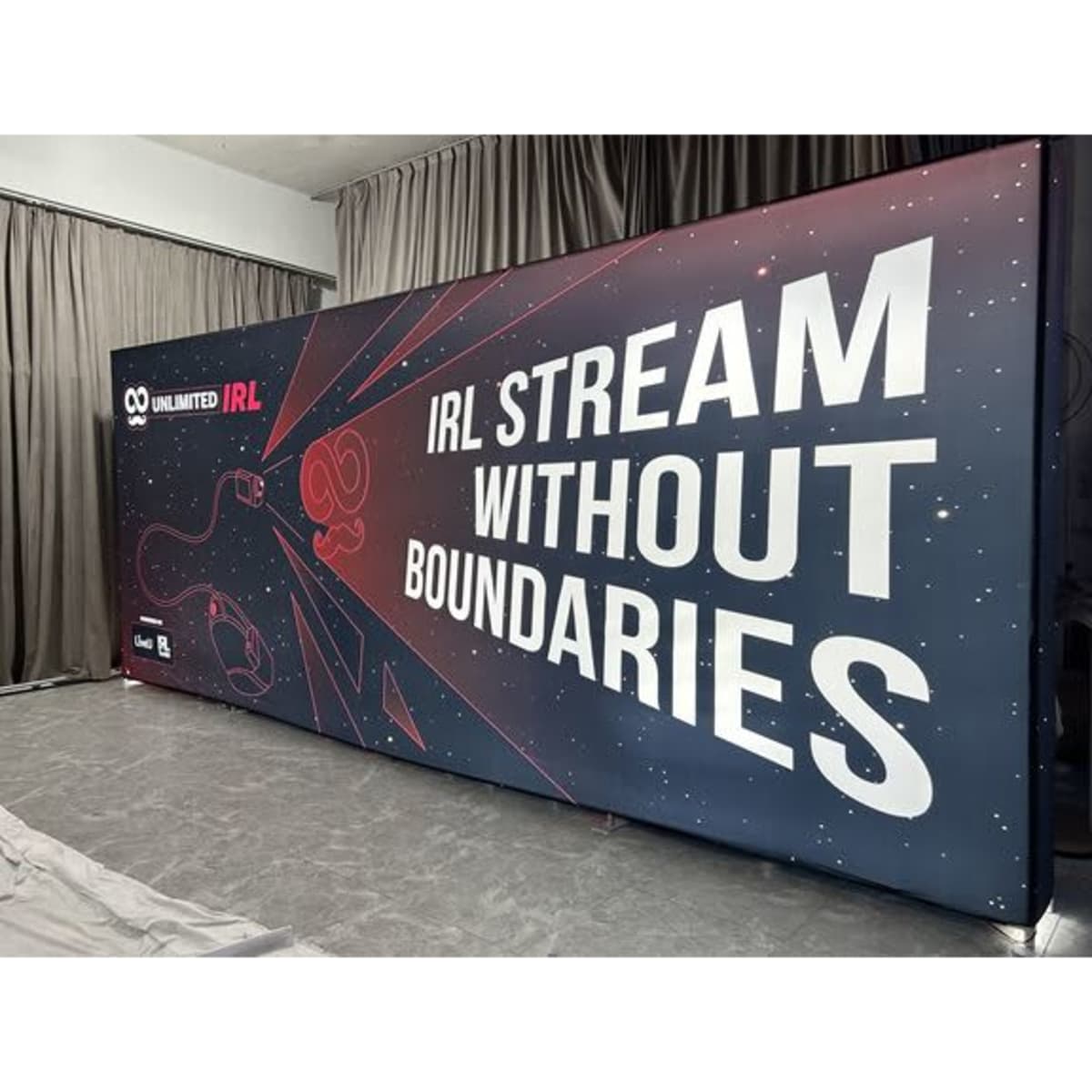 A large light box with a dark background featuring bold white text and a logo, designed for promotional use.