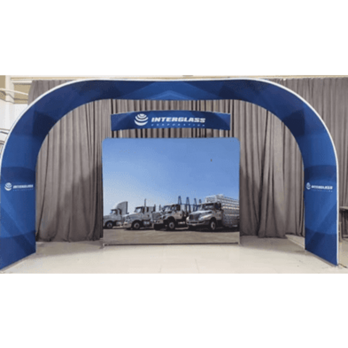 A large arch display with a blue and white design, featuring an image of trucks on a fabric background.