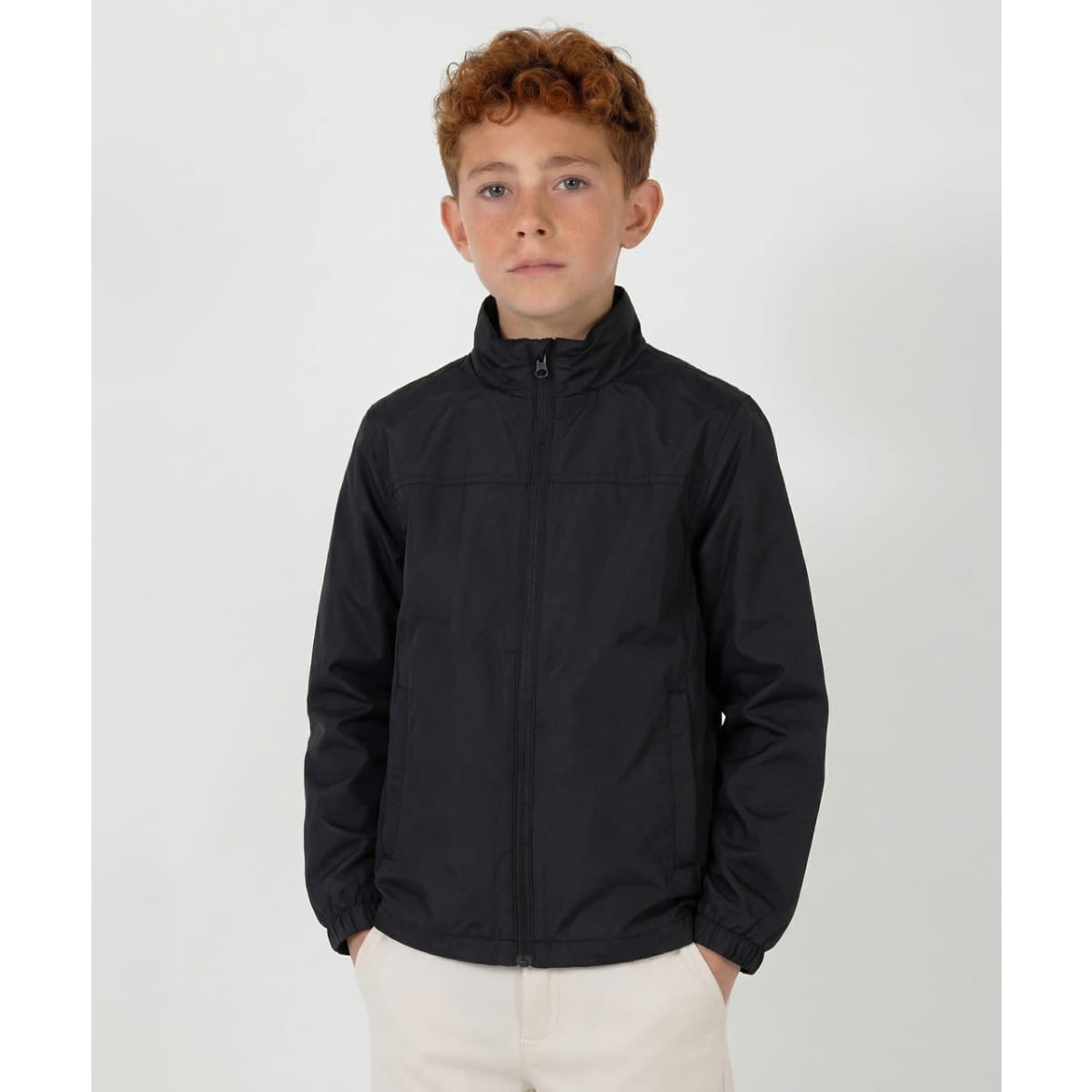 A youth black weather jacket with a zip front and elastic cuffs. It features a logo on the chest.