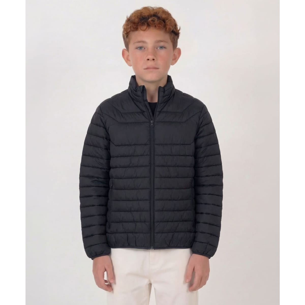 A black puffer jacket with a zip front and high collar, suitable for youth sizes, displayed on a model.