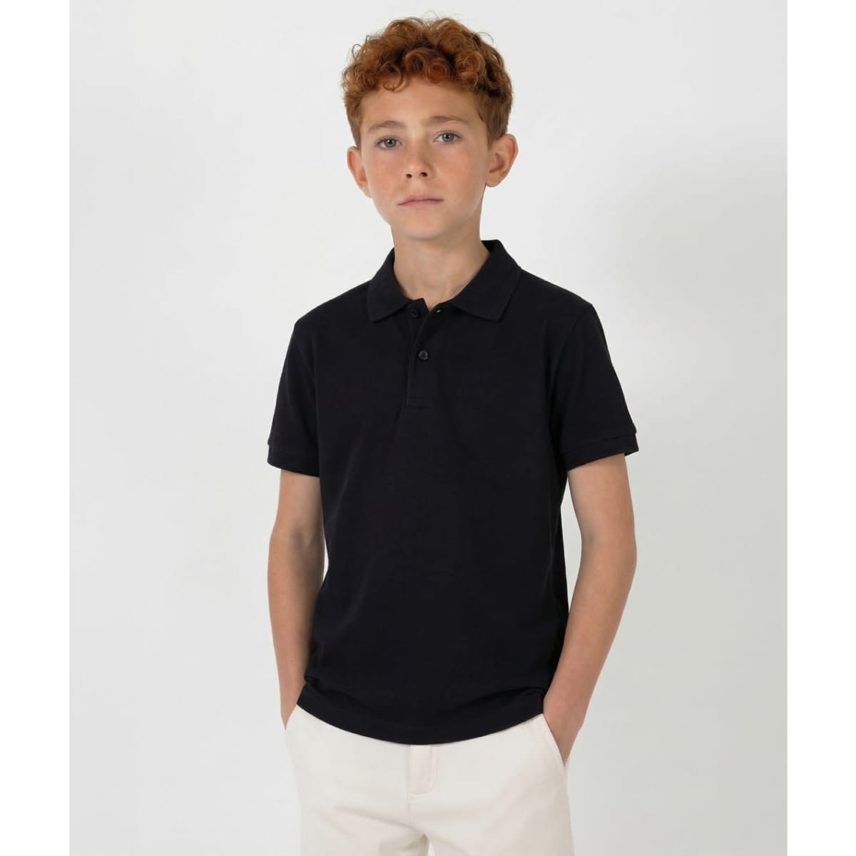 A black youth polo shirt with a classic collar and short sleeves, featuring a small logo on the chest.