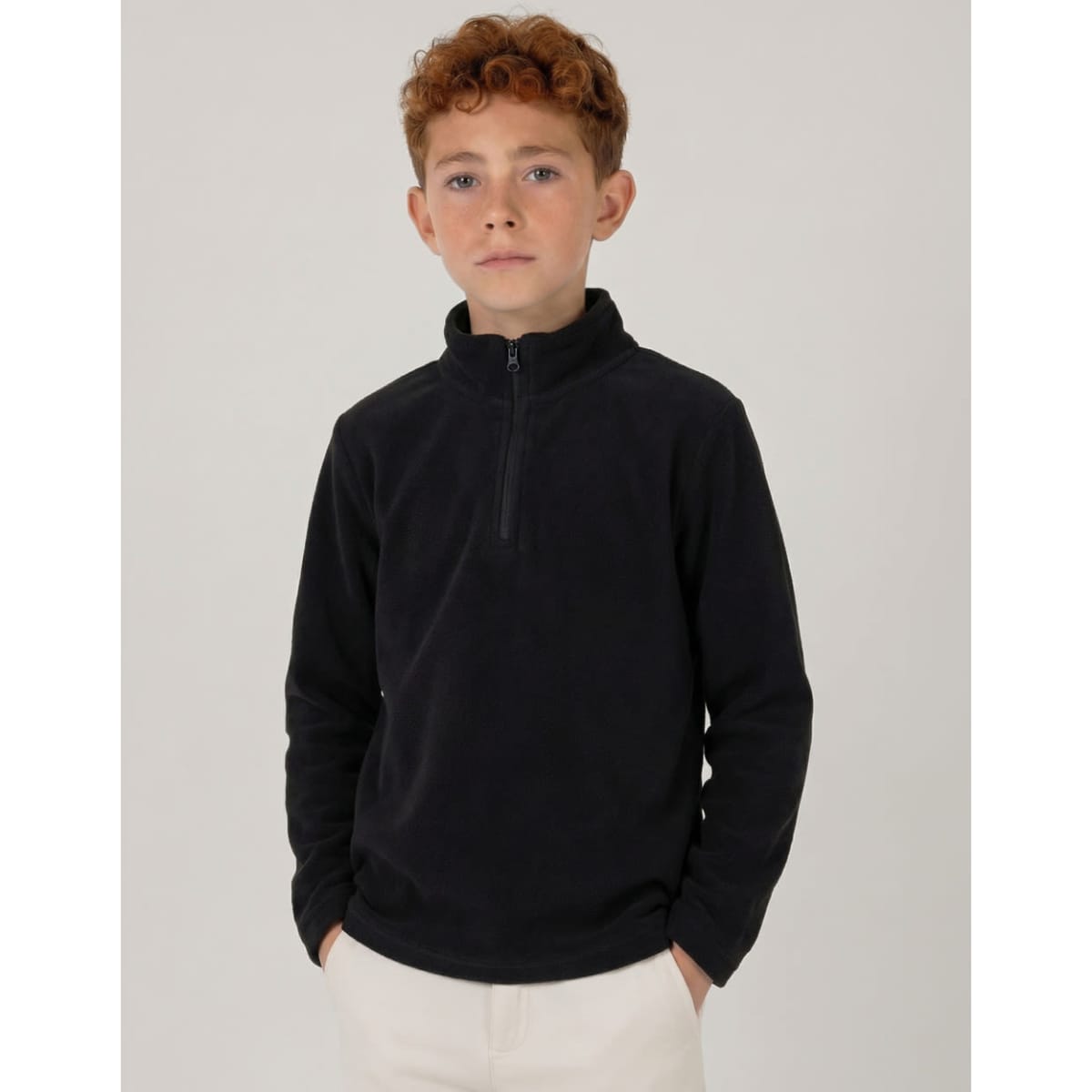 A black youth polar fleece jacket featuring a 1/4 zip, displayed on a young model.