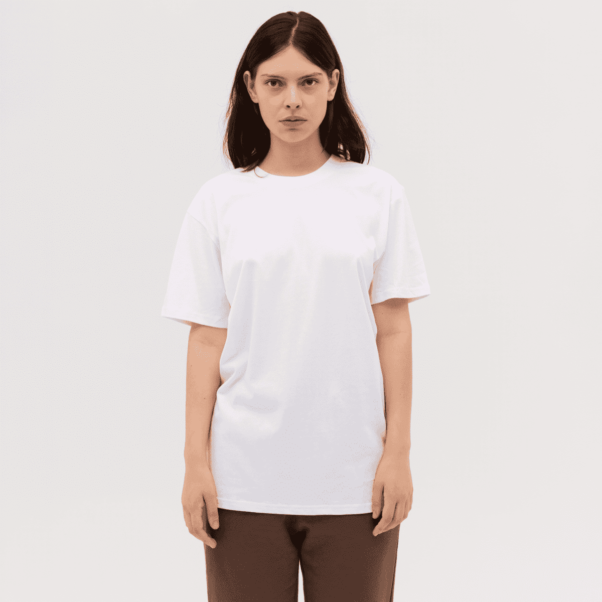 A plain white ladies' sport tee with short sleeves and a relaxed fit, featuring a logo.
