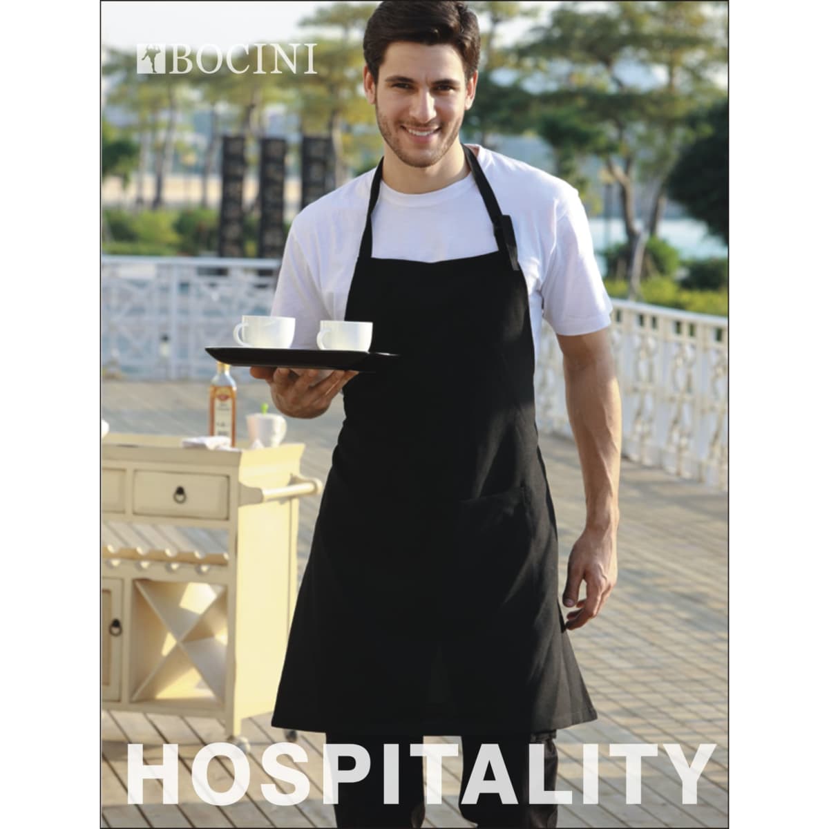 A black polyester drill full bib apron with a pocket, worn by a man holding a tray with two cups.