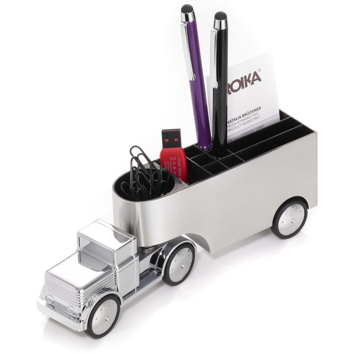 A desk organiser in the shape of a truck, featuring compartments for pens, a USB, and paper clips. It has a silver finish.