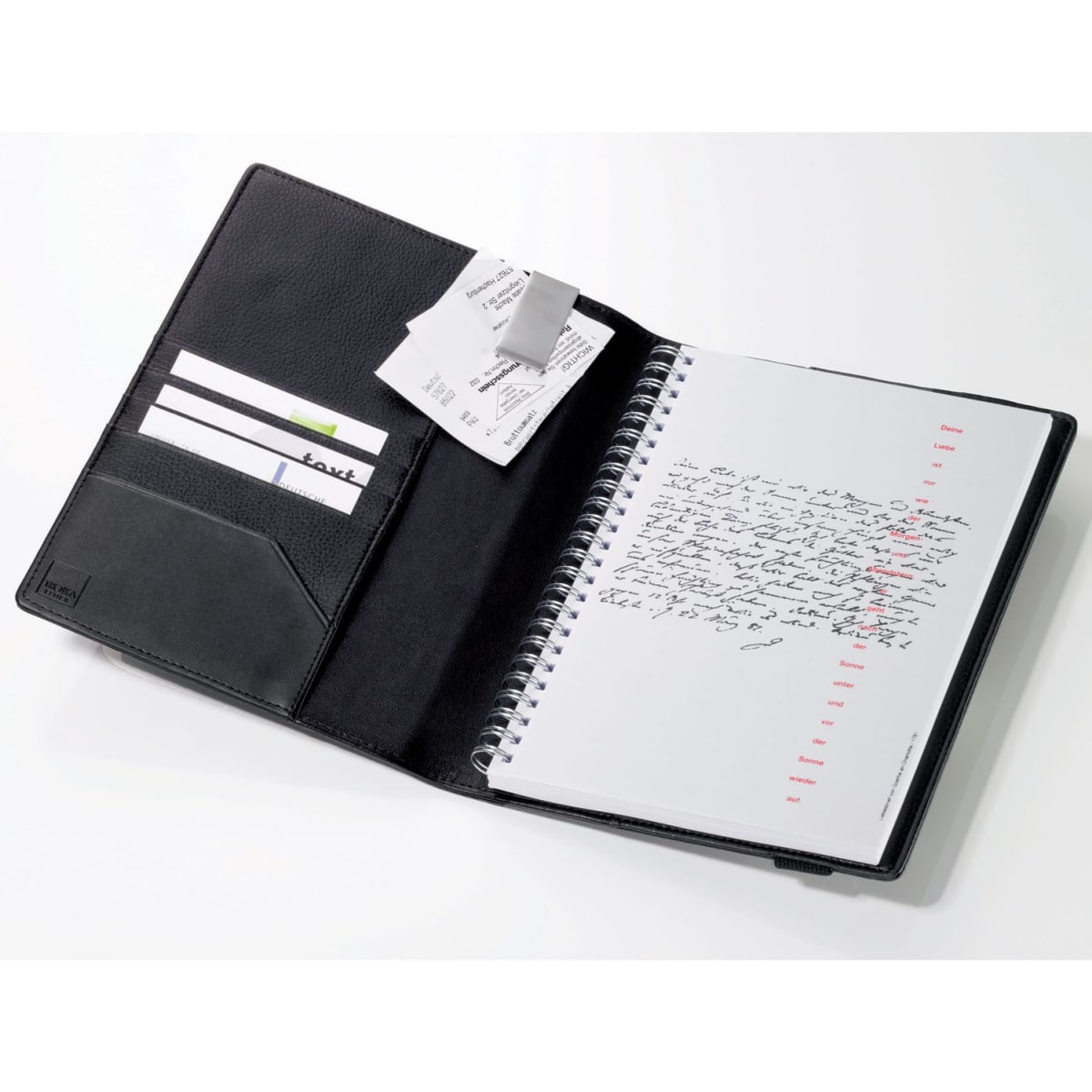 A notebook with a black cover, featuring a pocket for cards and a page with handwritten notes.