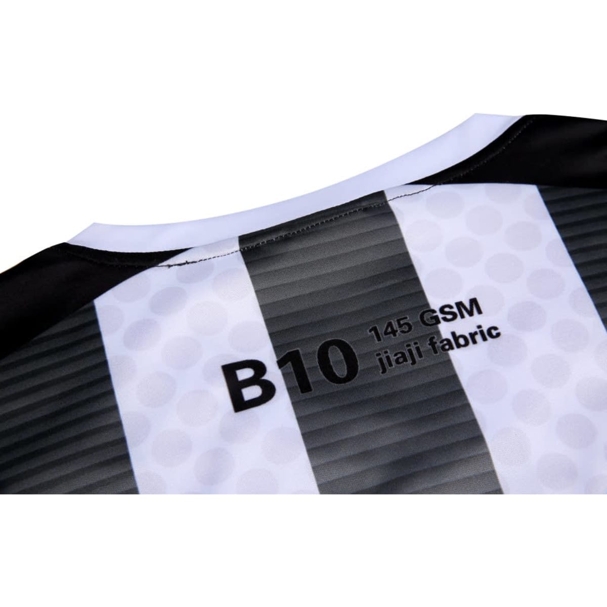A black and white jersey featuring a striped design and a label indicating fabric type and GSM.