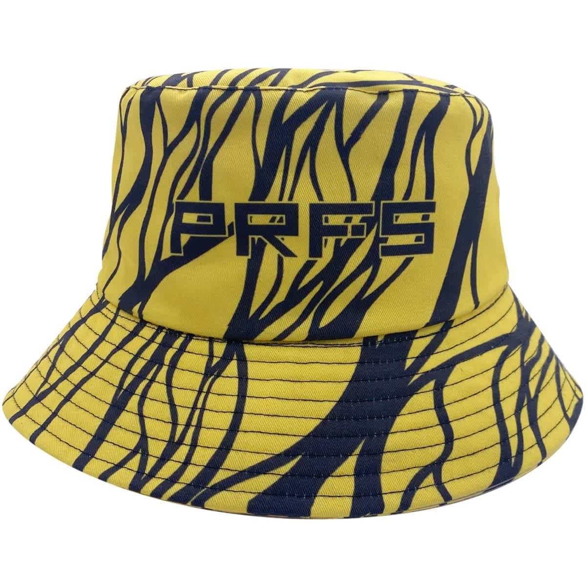 A reversible bucket hat featuring a yellow and navy abstract design, with a logo on the front.